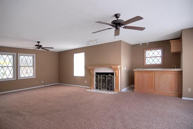 Living room, with fireplace, wet bar, and views of the pool!
