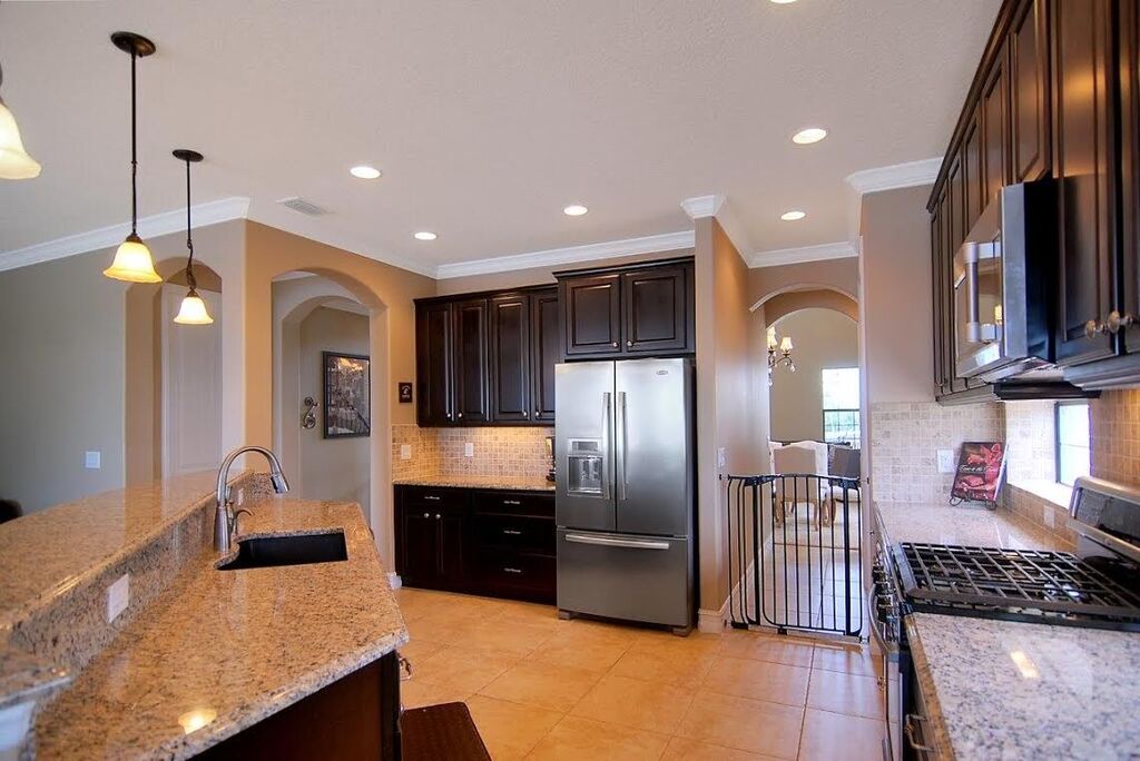 Open kitchen with gas range and stainless steel appliances