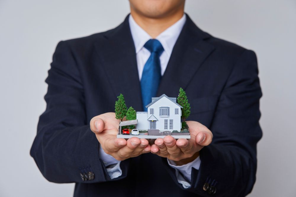 Real estate agent holding house model