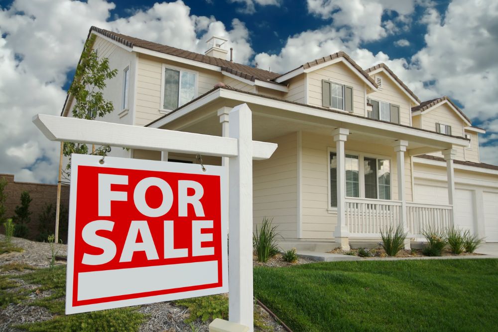 Modern home with for sale sign
