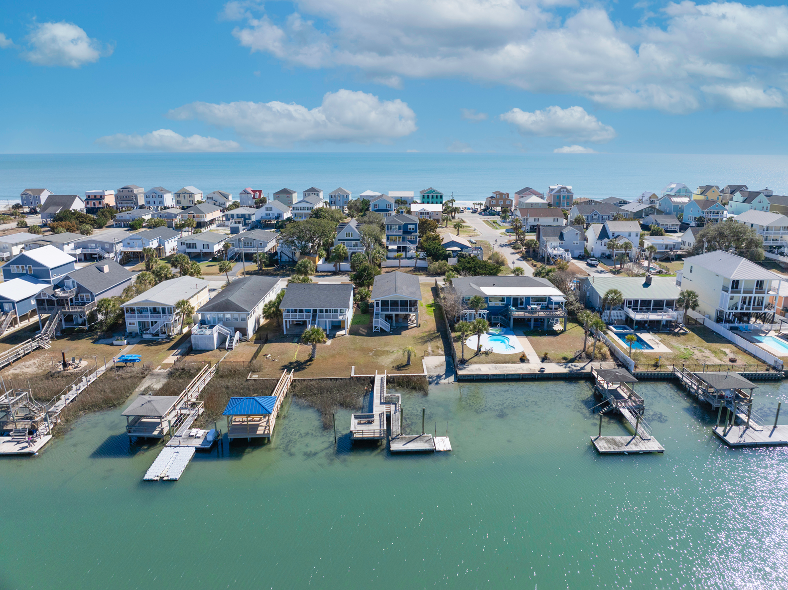 Creekfront homes in Garden City Beach, South Carolina overlooking the marsh and inlet with private docks, coastal architecture, and scenic water views along the South Strand.