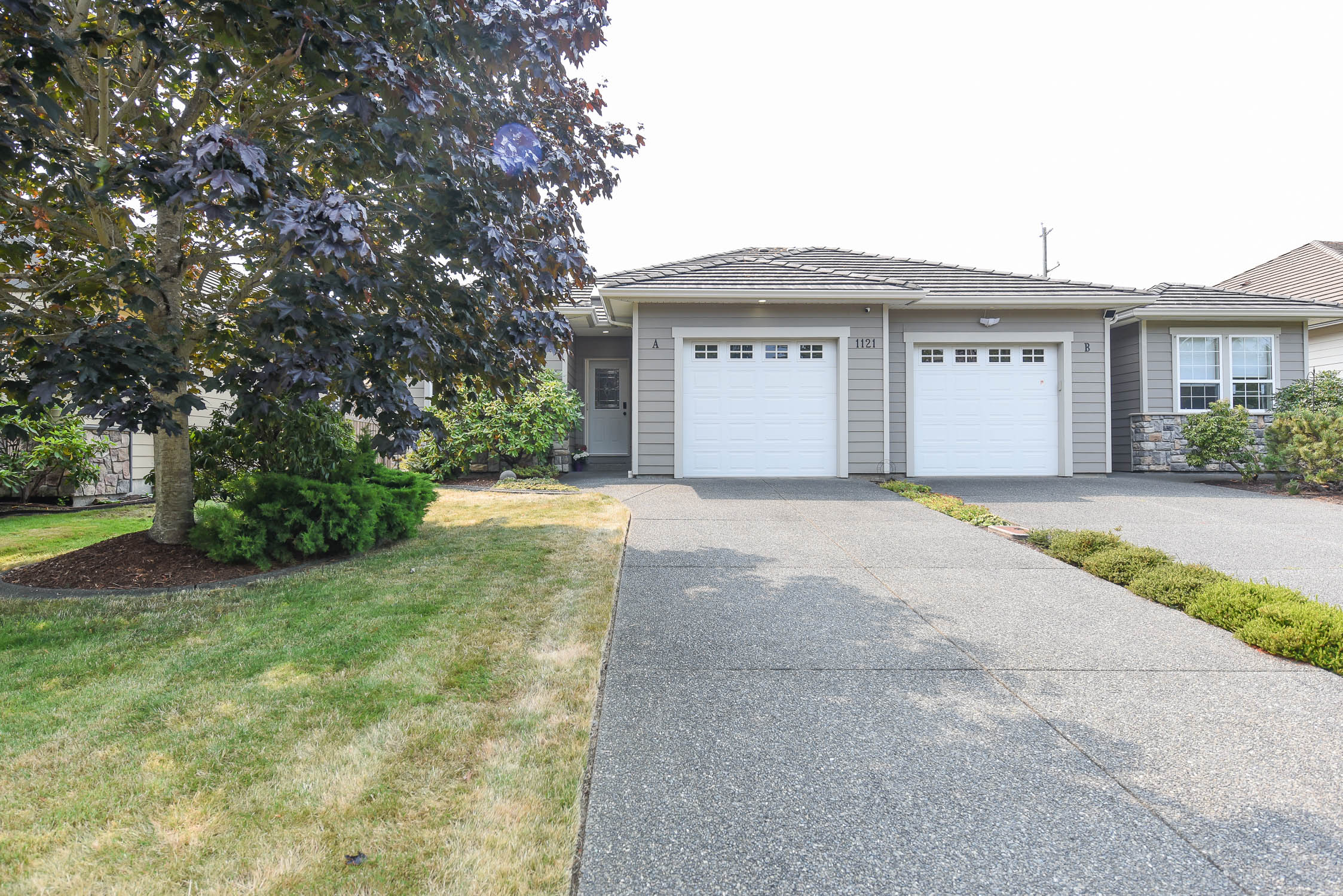 Well-kept 3-bedroom half duplex at 1121A Monarch Dr in Crown Isle featuring one-level living, a bright open-concept interior, private fenced backyard, and no strata fees.