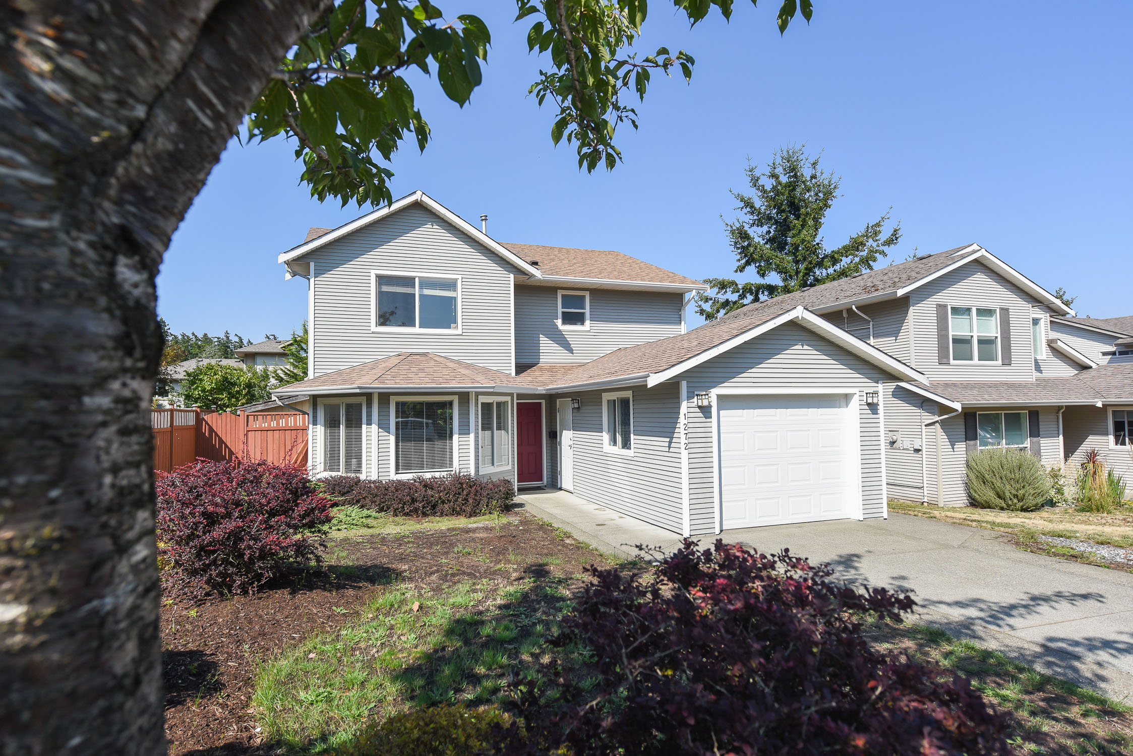 Spacious 4-bedroom family home at 1272 Crown Place in Central Comox featuring a quiet cul-de-sac setting, renovated primary ensuite, fully fenced backyard, and large deck for outdoor entertaining.
