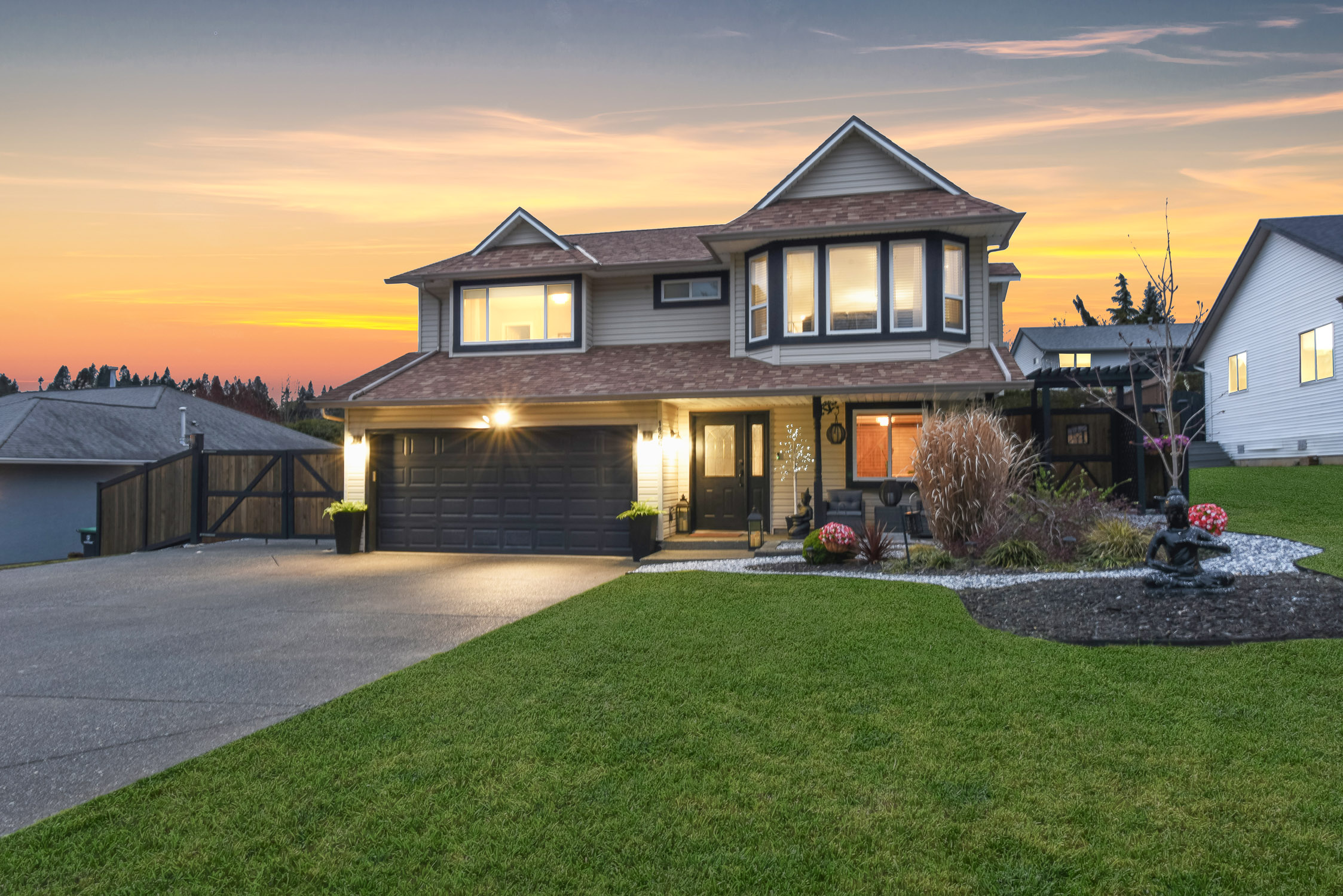 private backyard at 1866 hawk dr courtenay bc showing mature landscaped oasis with walkways and rv parking access
