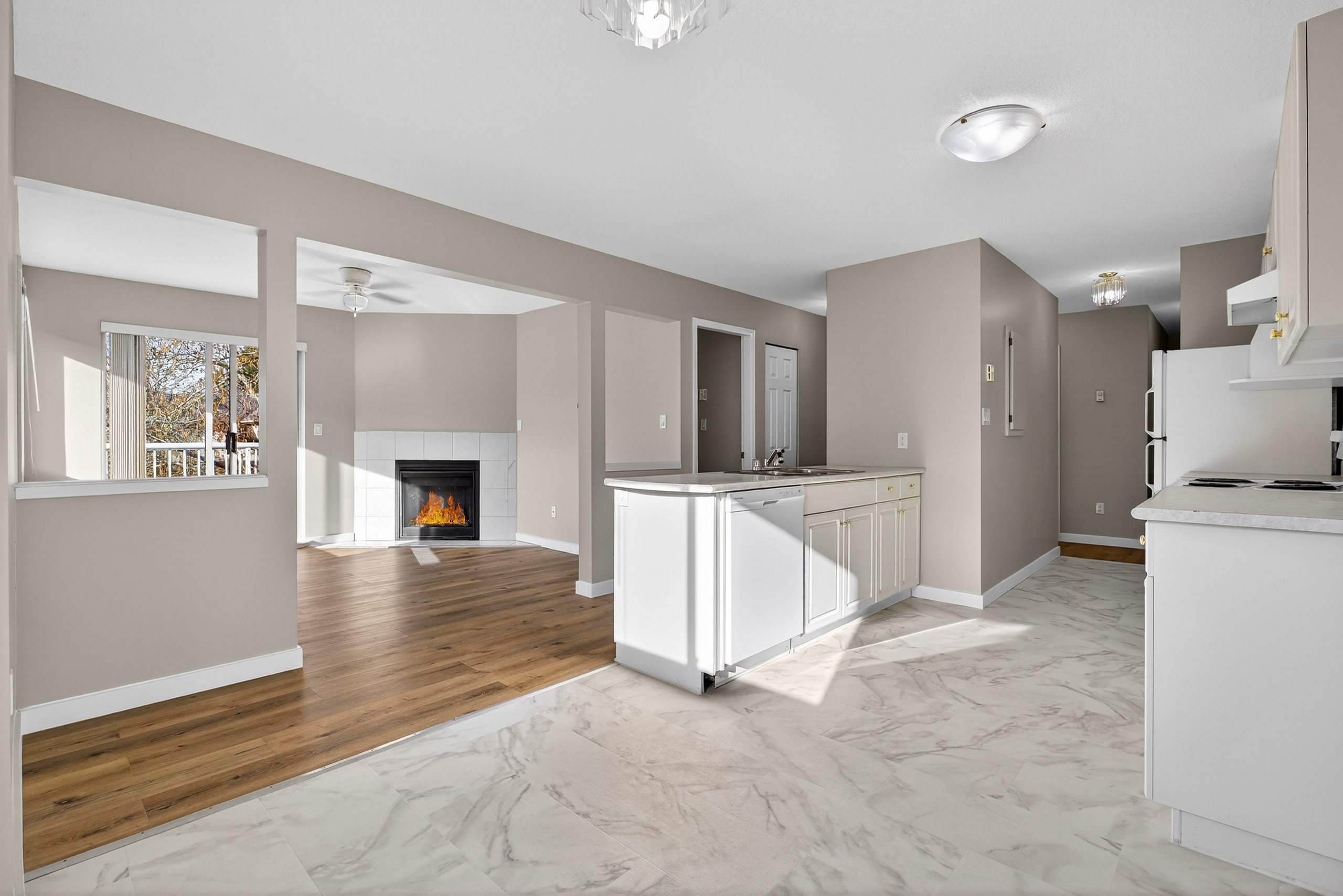 south facing corner unit at 202 2647 muir rd courtenay bc showing bright condo with mountain views private balcony and gas fireplace