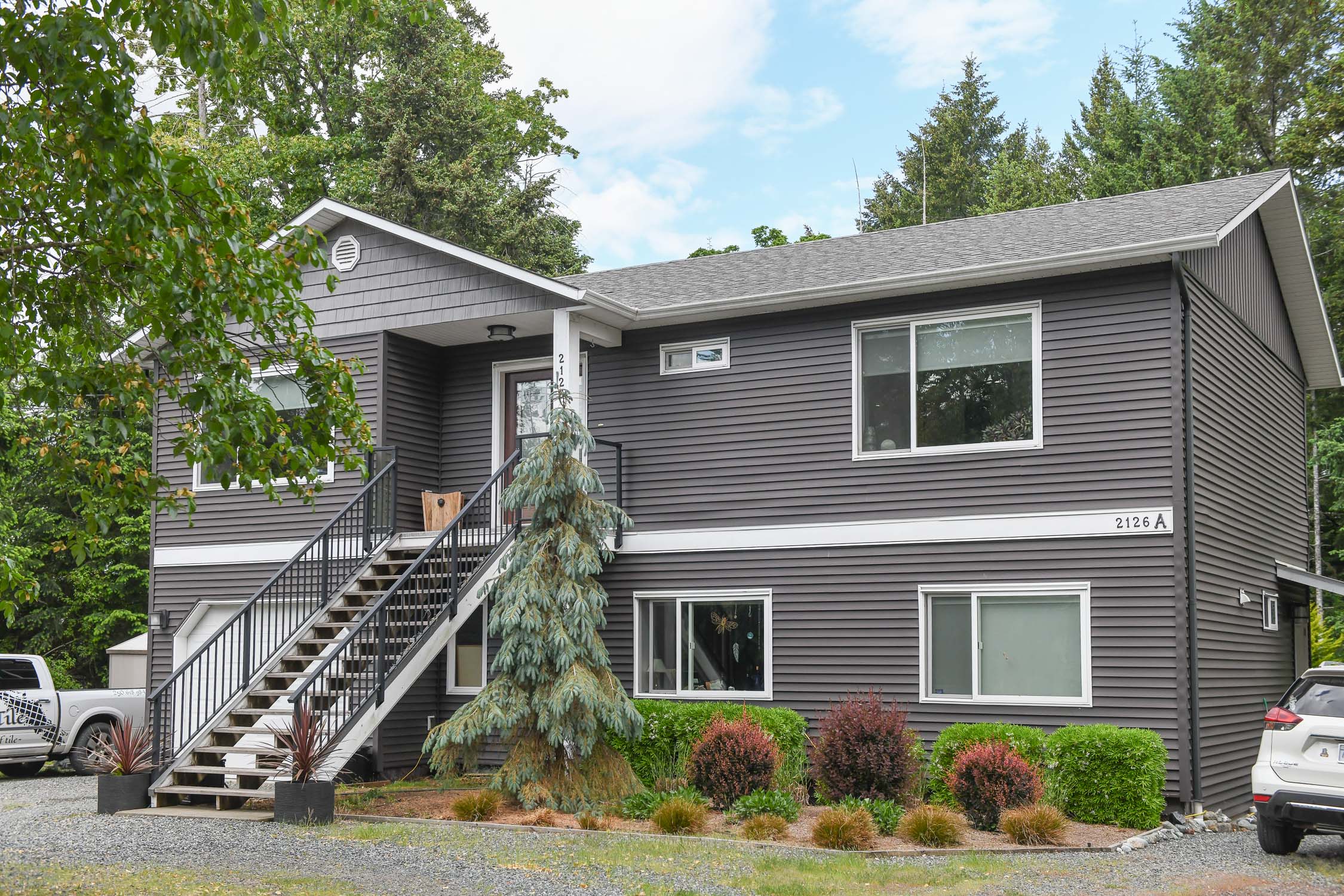Beautifully designed home at 2126 Cypress Rd in Comox featuring open-concept living, legal 1-bedroom suite, oversized garage, and a stunning private backyard in a quiet family-friendly neighbourhood.