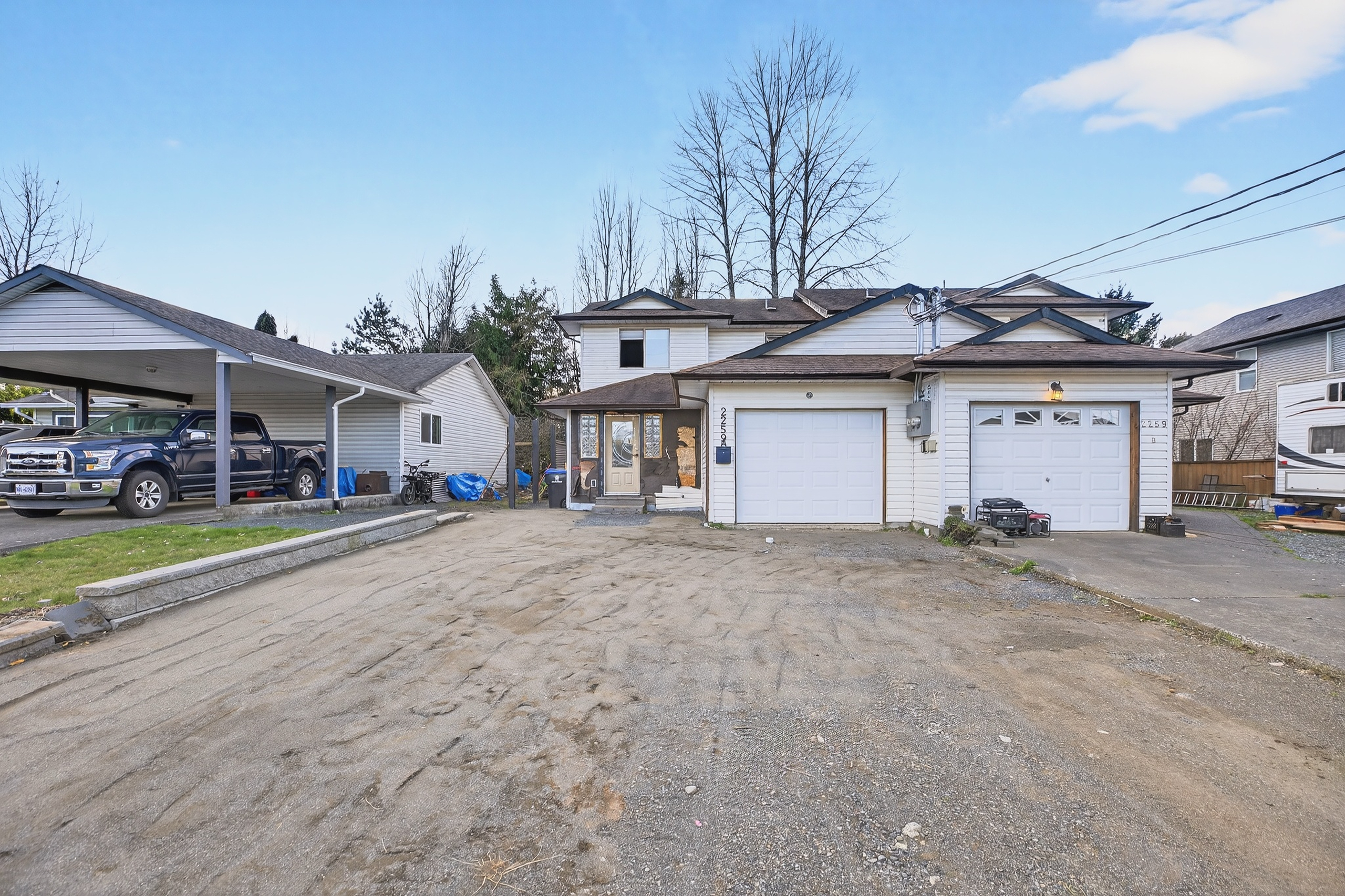 Exterior of 2259A Urqhart Ave, Courtenay half duplex featuring attached single-car garage and functional residential design, situated in a central Courtenay neighbourhood close to schools, shopping, and amenities. This fixer upper property presents strong renovation and investment potential with excellent curb appeal opportunity for value-added improvements in the Comox Valley real estate market.