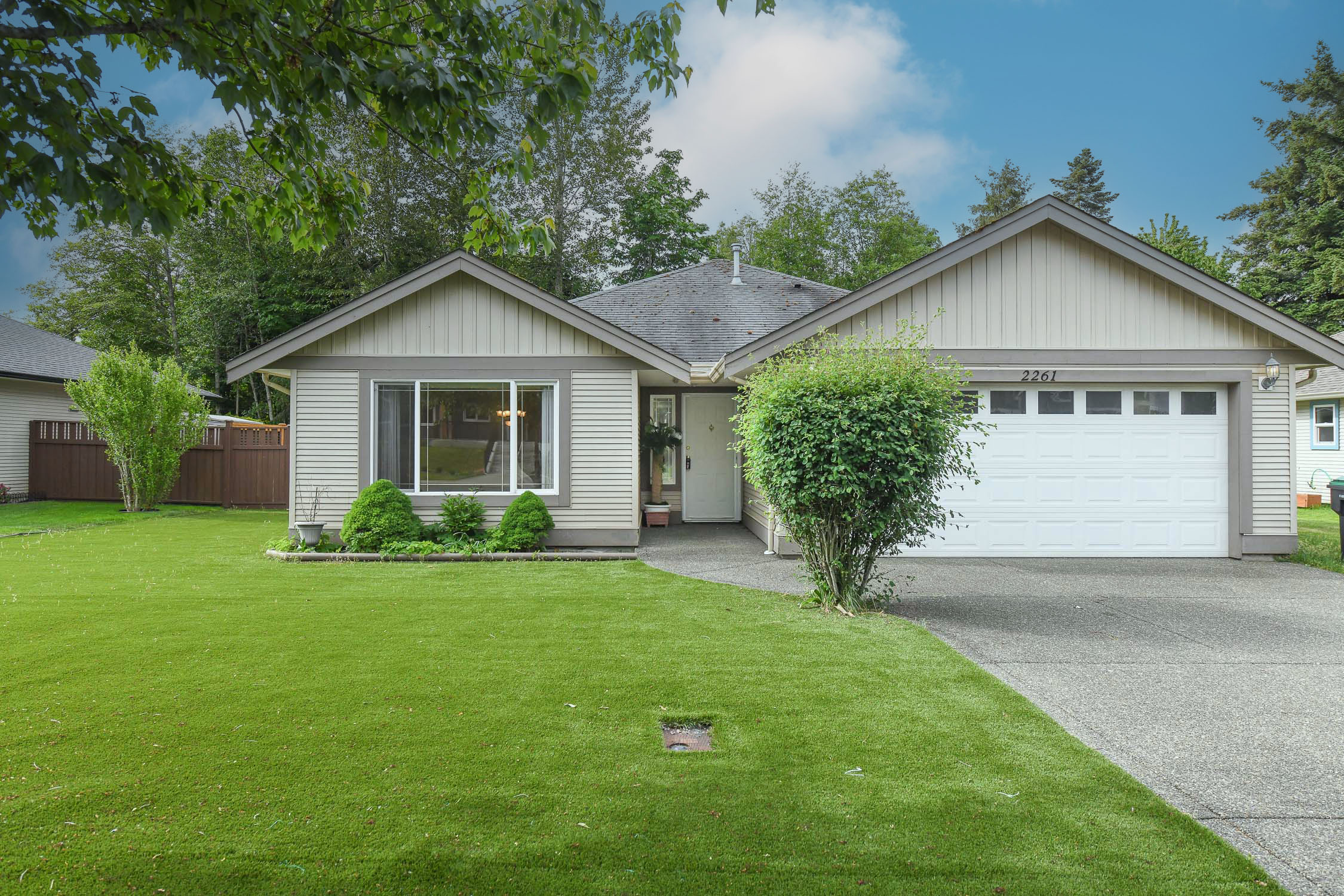 Beautiful rancher at 2261 Murrelet Dr in Comox featuring one-level living, a cozy gas fireplace, and a sunny south-facing backyard backing directly onto Aspen Park Elementary School fields.