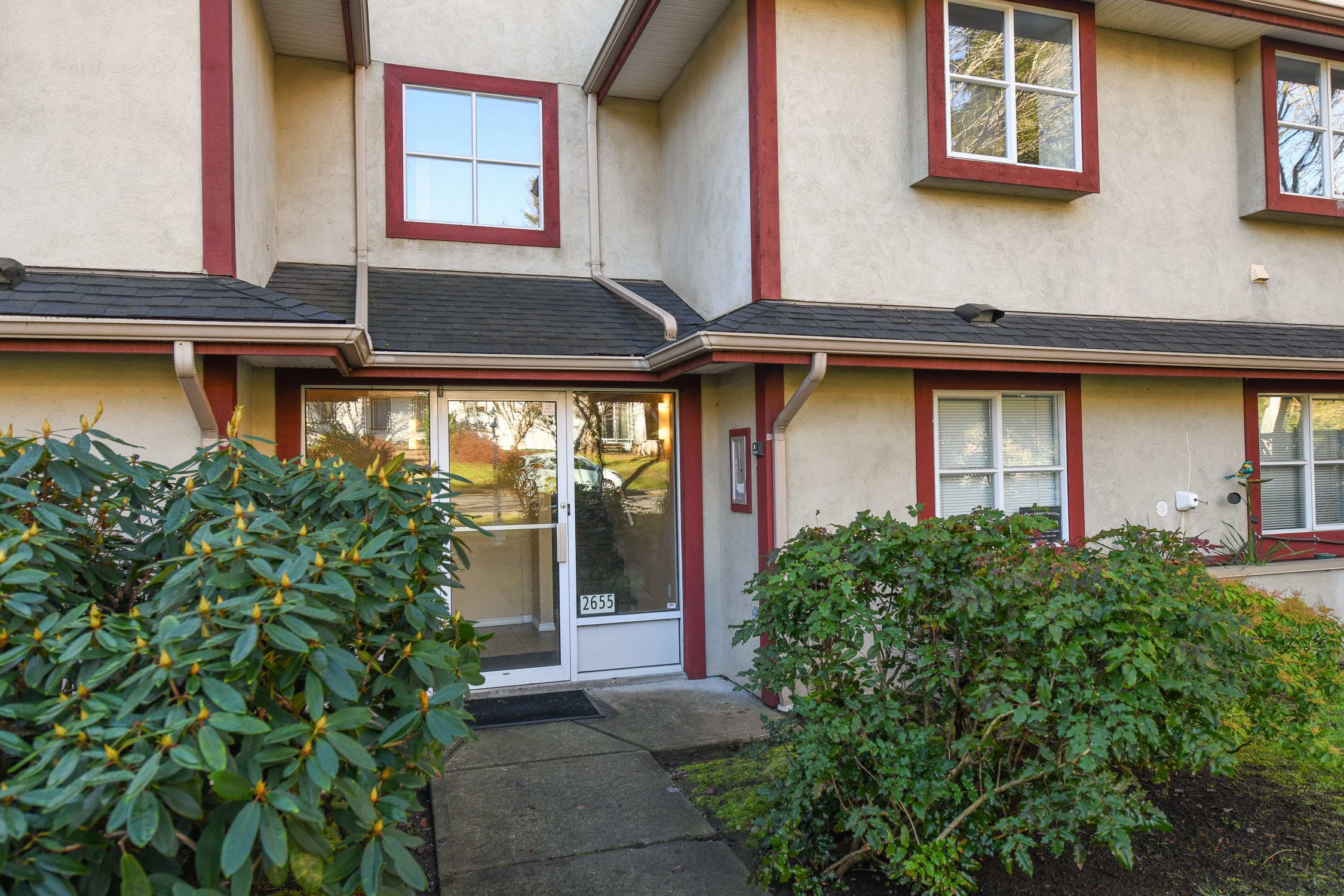 exterior view of 201 2655 muir rd courtenay bc showing bright corner unit condo in well maintained building