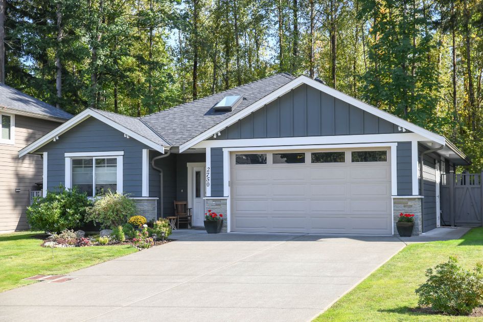 Front exterior of 2750 Swanson St, Courtenay, BC &ndash; a modern 3-bedroom, 2-bath rancher featuring a double garage, manicured landscaping, and welcoming curb appeal in a quiet West Courtenay neighborhood.