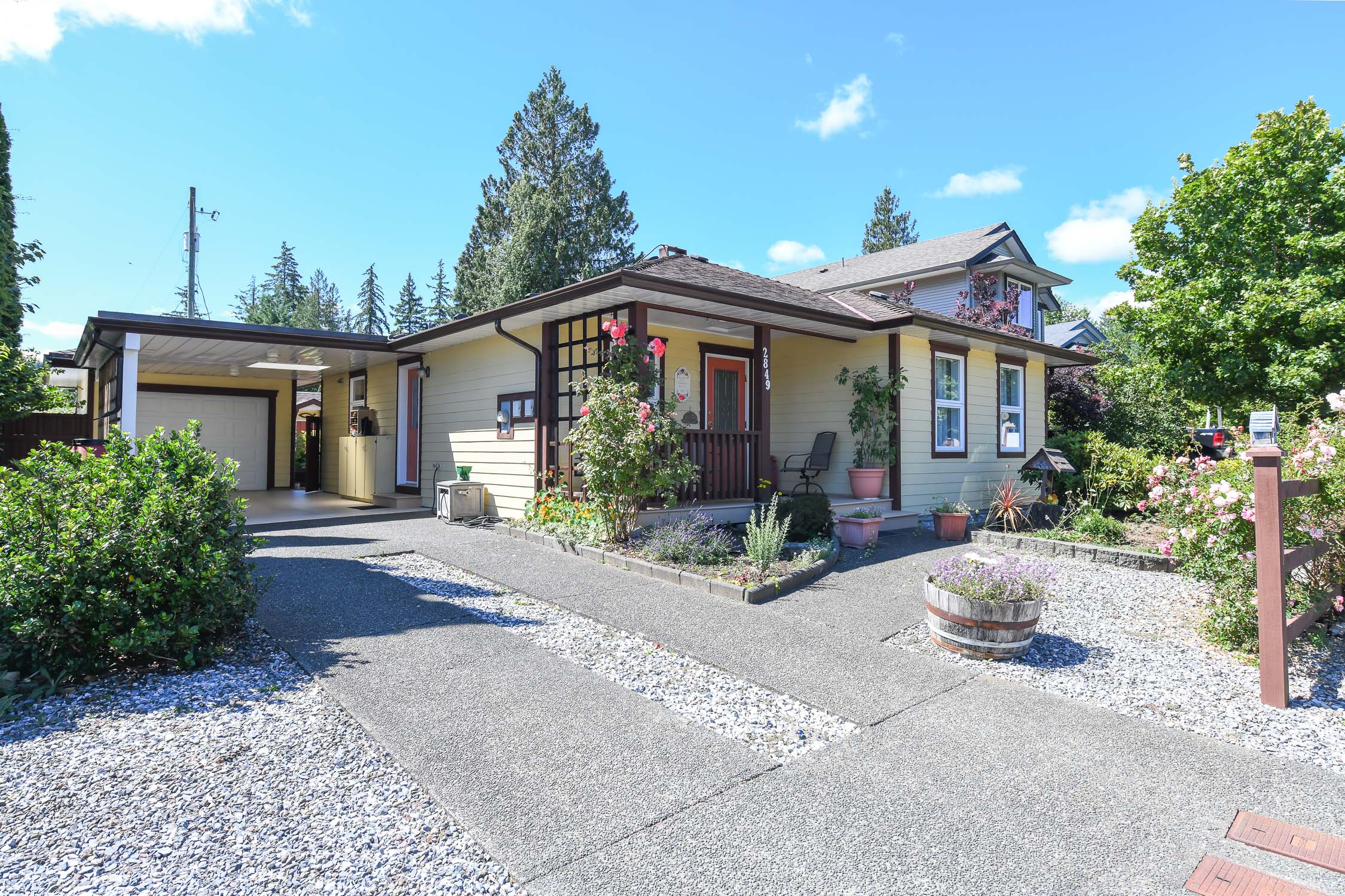 Custom-built rancher at 2849 Penrith Ave in Cumberland featuring energy-efficient design, a sun-filled south-facing garden, greenhouse, versatile garage, and easy access to downtown Cumberland, parks, and world-class mountain biking.