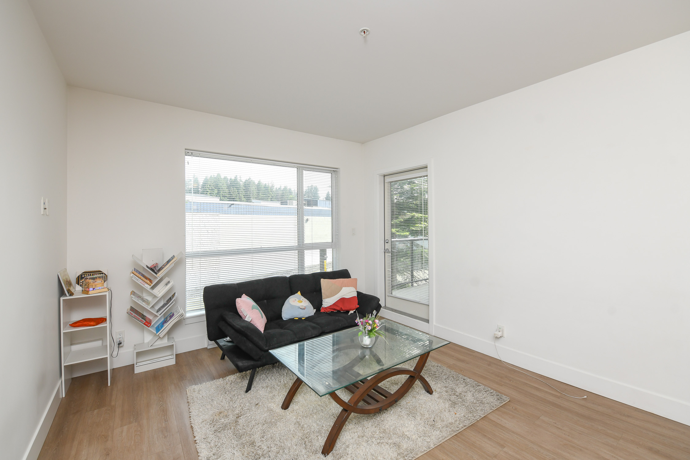 Modern south-facing condo at #310 3070 Kilpatrick Ave in Courtenay featuring upgraded quartz countertops, stainless steel appliances, open-concept living, and abundant natural light in Newport Village.