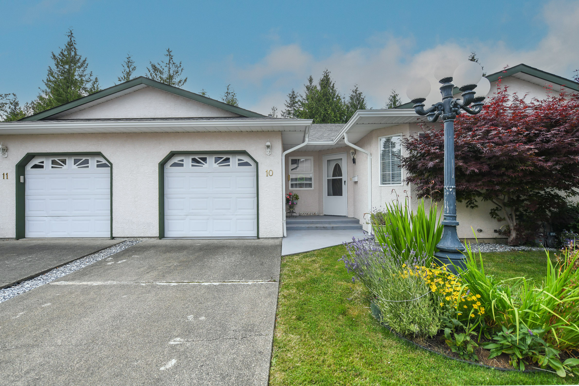 Beautifully maintained 55+ patio home at #10 3355 First St in Cumberland featuring a spacious west-facing deck, cozy natural gas fireplace, and easy access to downtown Cumberland, scenic trails, and world-class mountain biking.