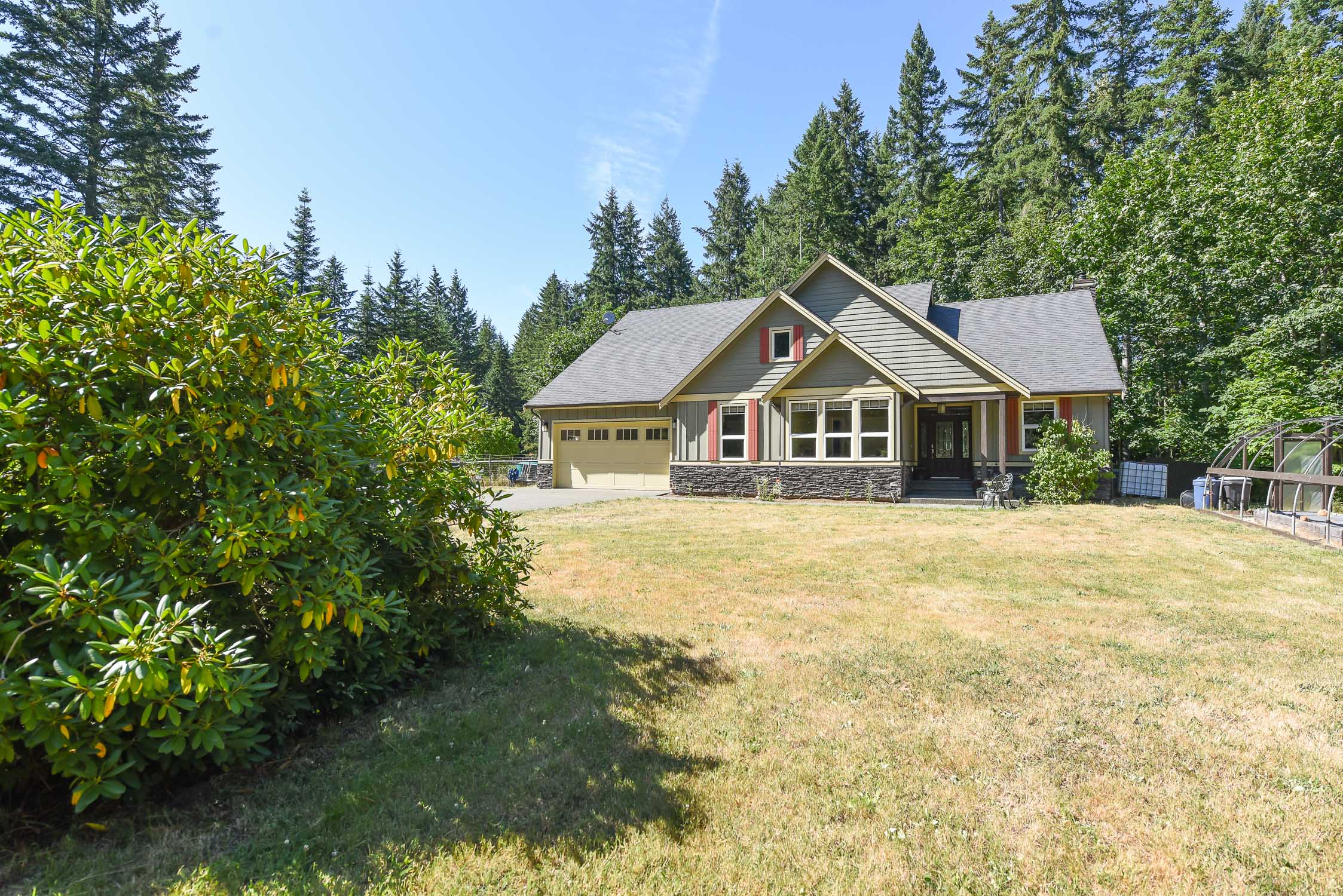 A private 5-acre dual-residence property in Black Creek featuring two detached homes surrounded by mature trees, expansive yard space, and a large detached shop&mdash;showcasing rural Vancouver Island living with acreage, privacy, and multi-home flexibility
