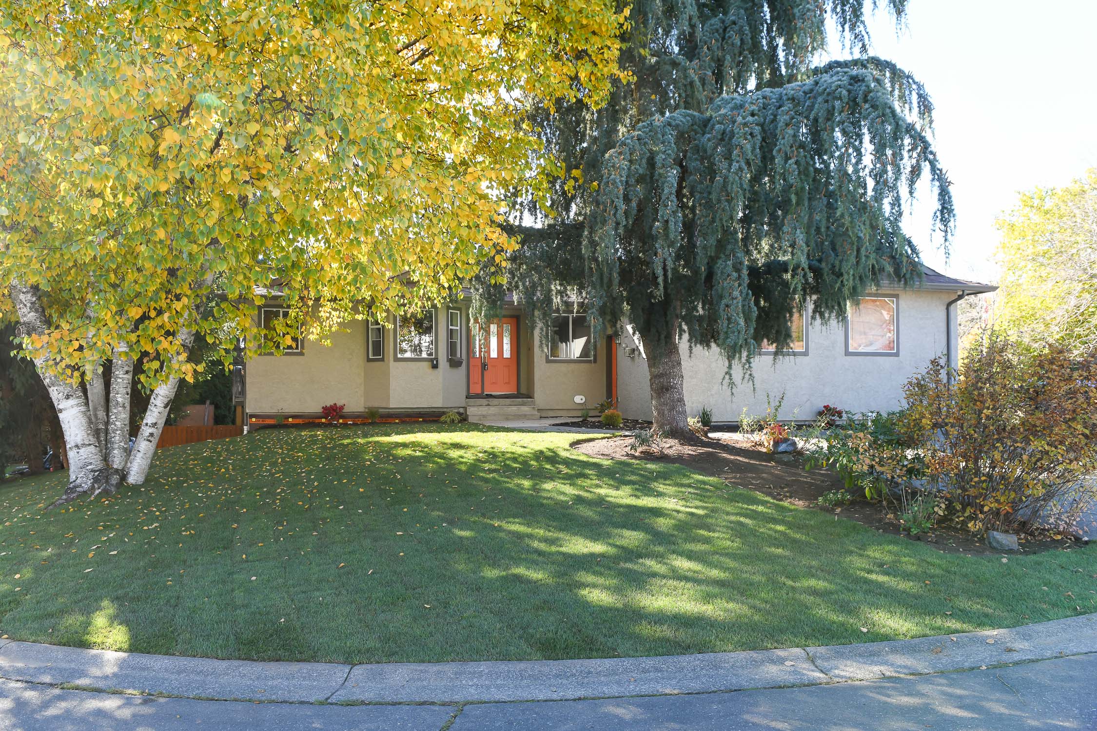 Vacant level-entry home at 349 Durrand Pl in Courtenay East featuring new engineered hardwood flooring, a partially covered full-length deck, glacier and mountain views, a fenced landscaped yard and a self-contained one-bedroom in-law suite.