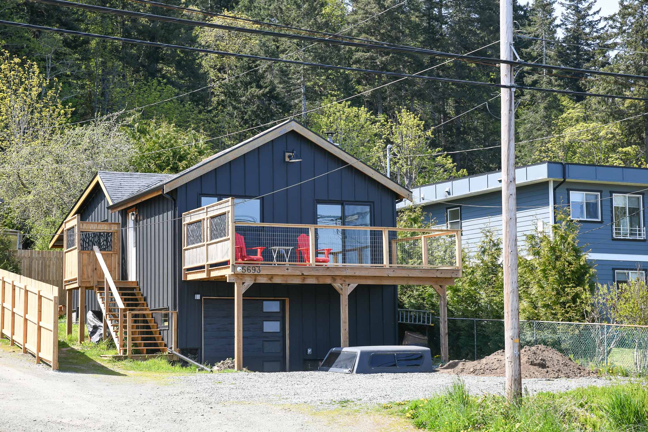 exterior view of 5693 island hwy south union bay bc showing detached ocean view home with coastal west coast design