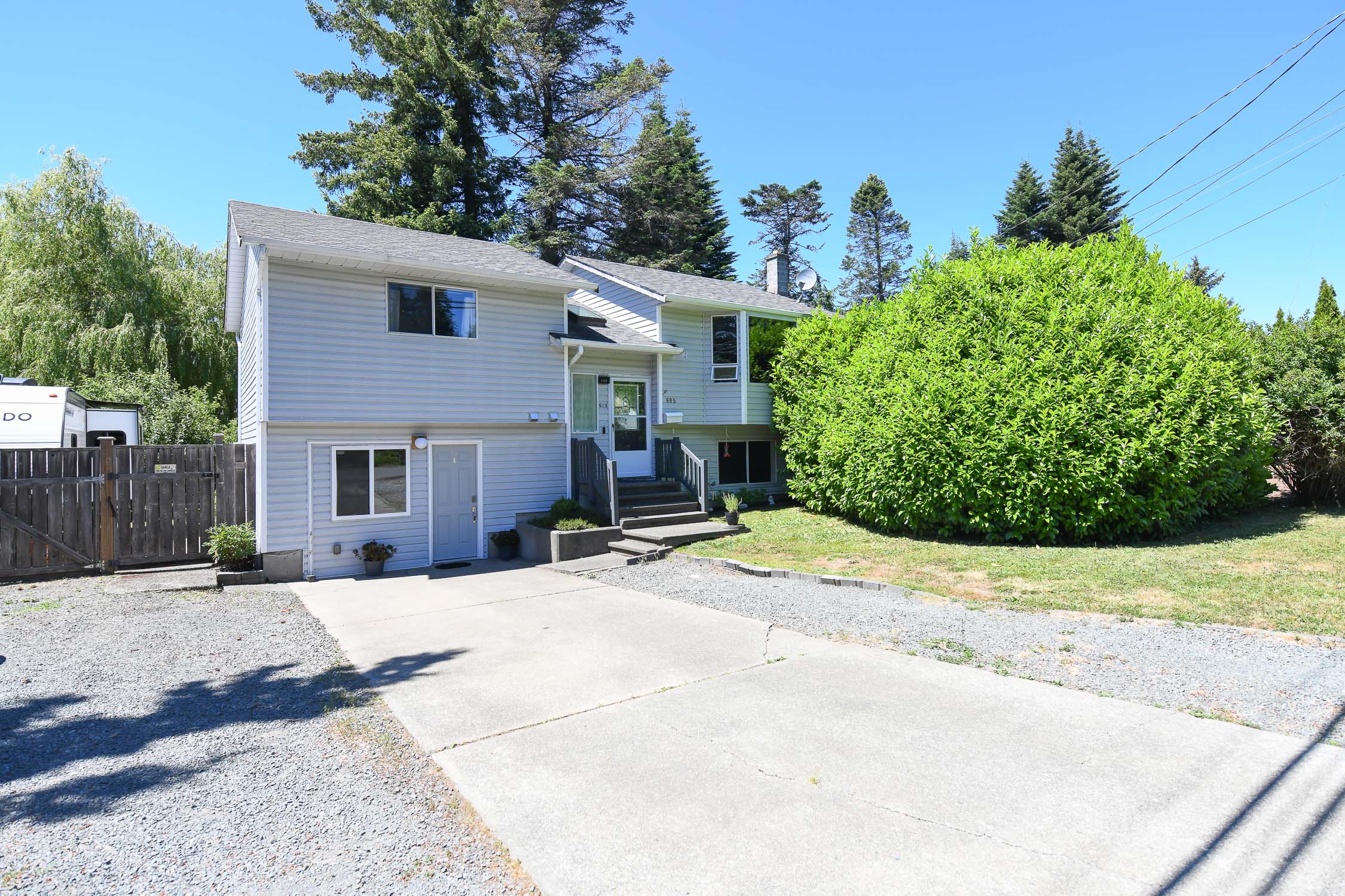 Spacious family home at 605 Pritchard Pl in Comox featuring a self-contained in-law suite, oversized fenced yard, mature fruit trees, hot tub, and ample parking for RVs, boats, and recreational vehicles.