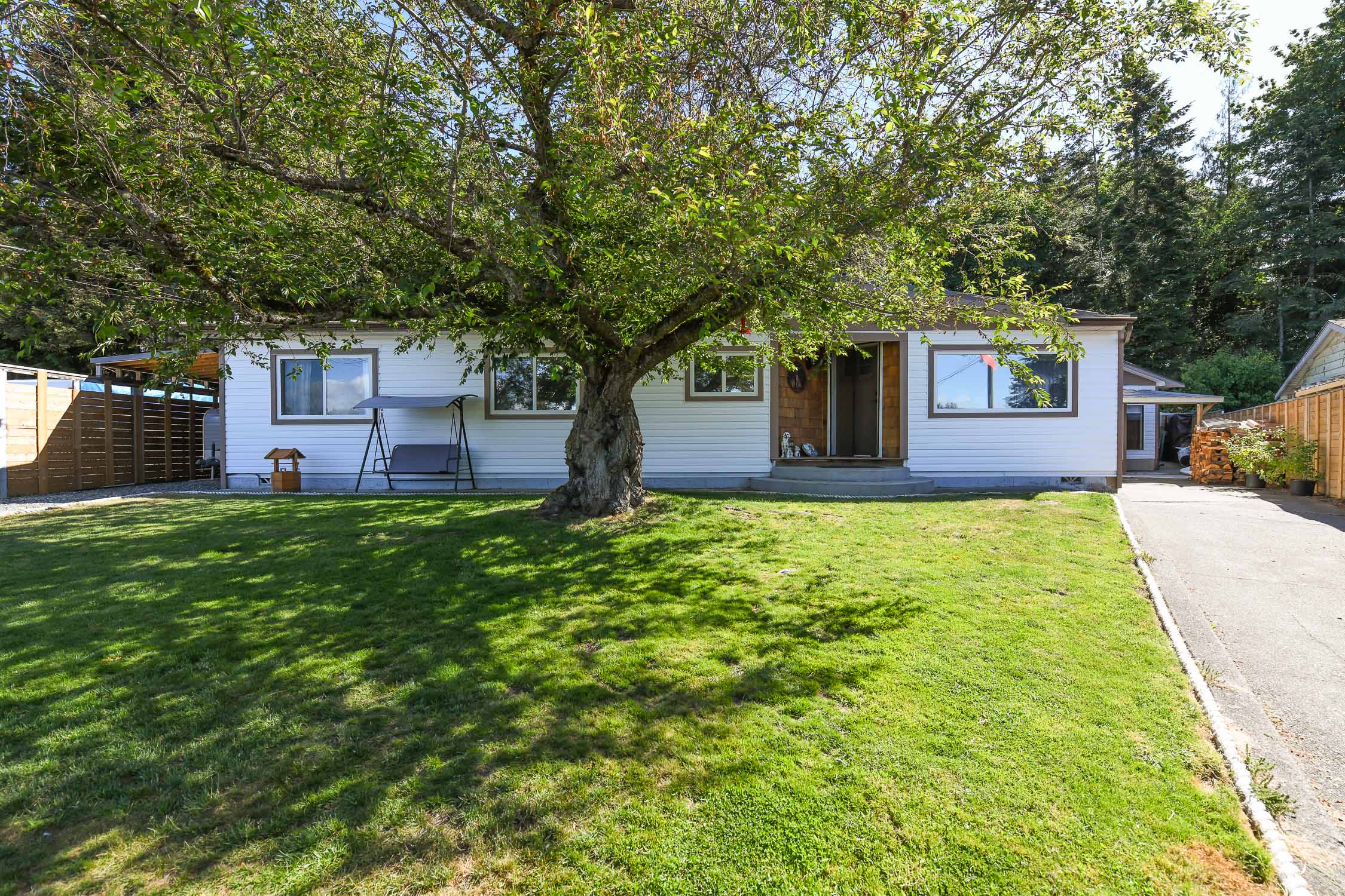 Updated rancher at 610 Nechako Ave in Courtenay featuring mountain views, vaulted ceilings, landscaped backyard, detached garage space, and private access to nature park trails.
