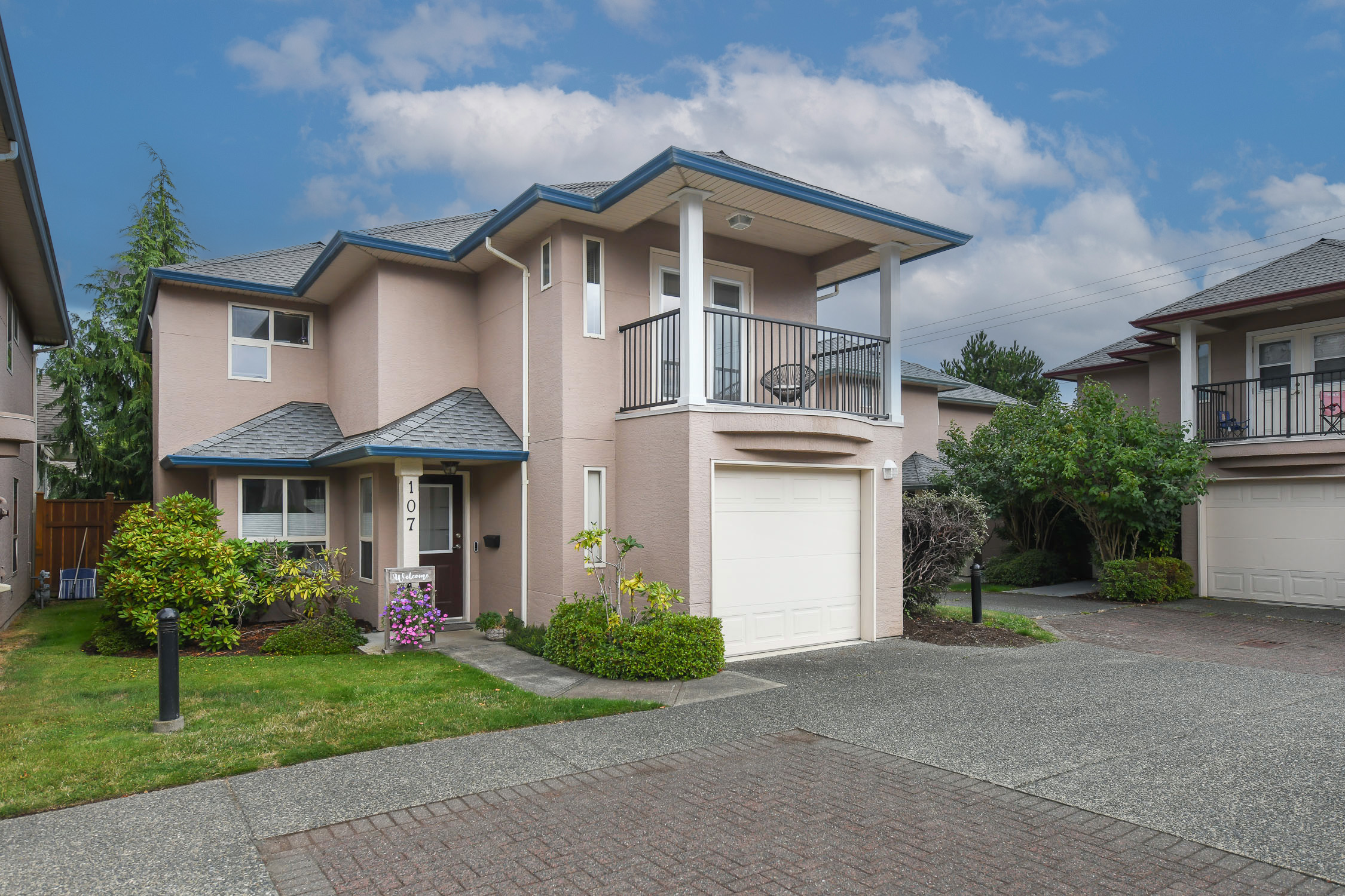 Detached two-storey home at #107 720 Aspen Rd in Comox's Christie Heights featuring bright open-concept living, a new gas fireplace, private balcony, and a low-maintenance lifestyle close to parks, schools, shopping, and walking trails.