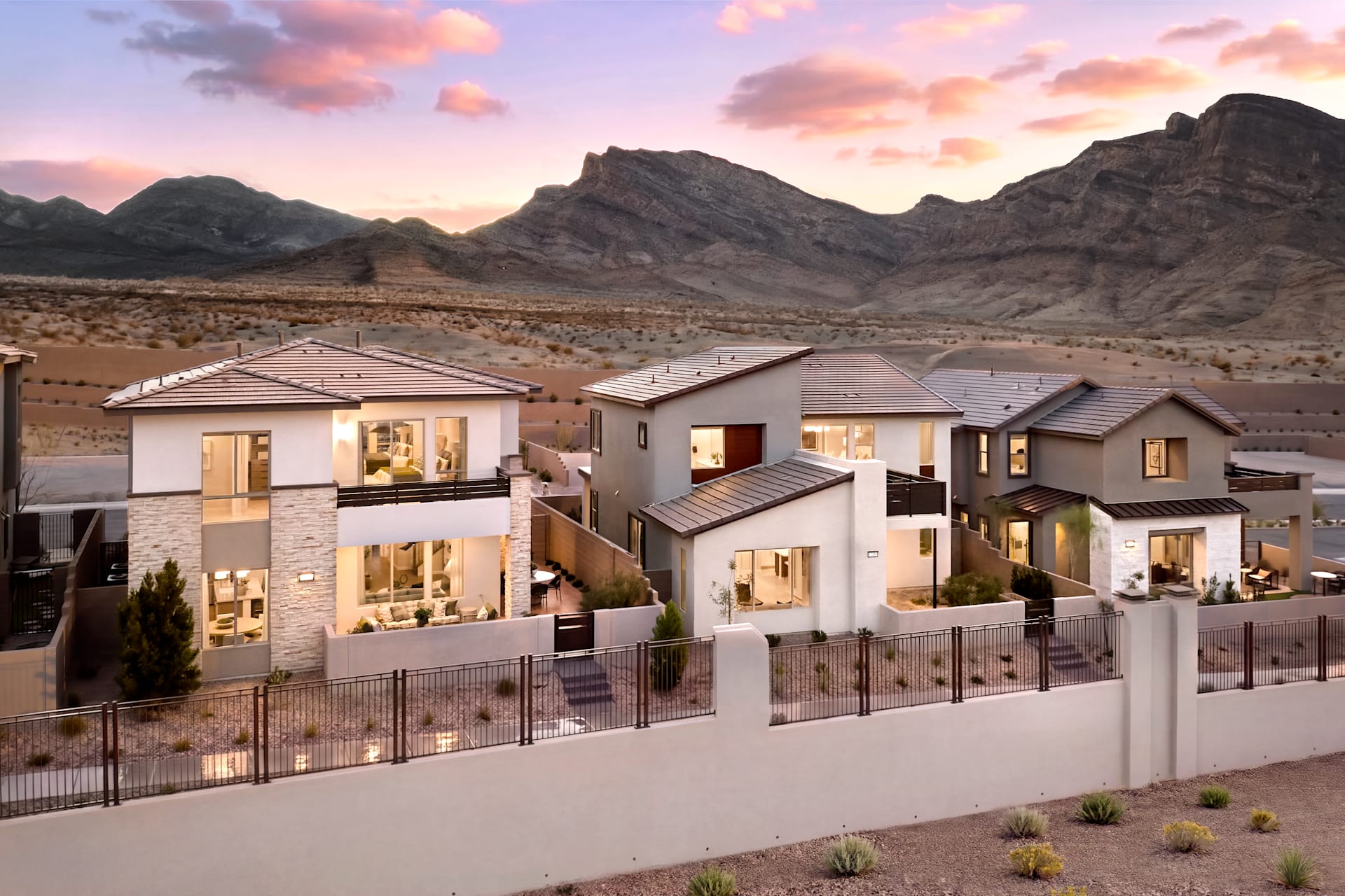 Two-story homes at Aberdeen by Tri Pointe Homes at dusk with mountain views