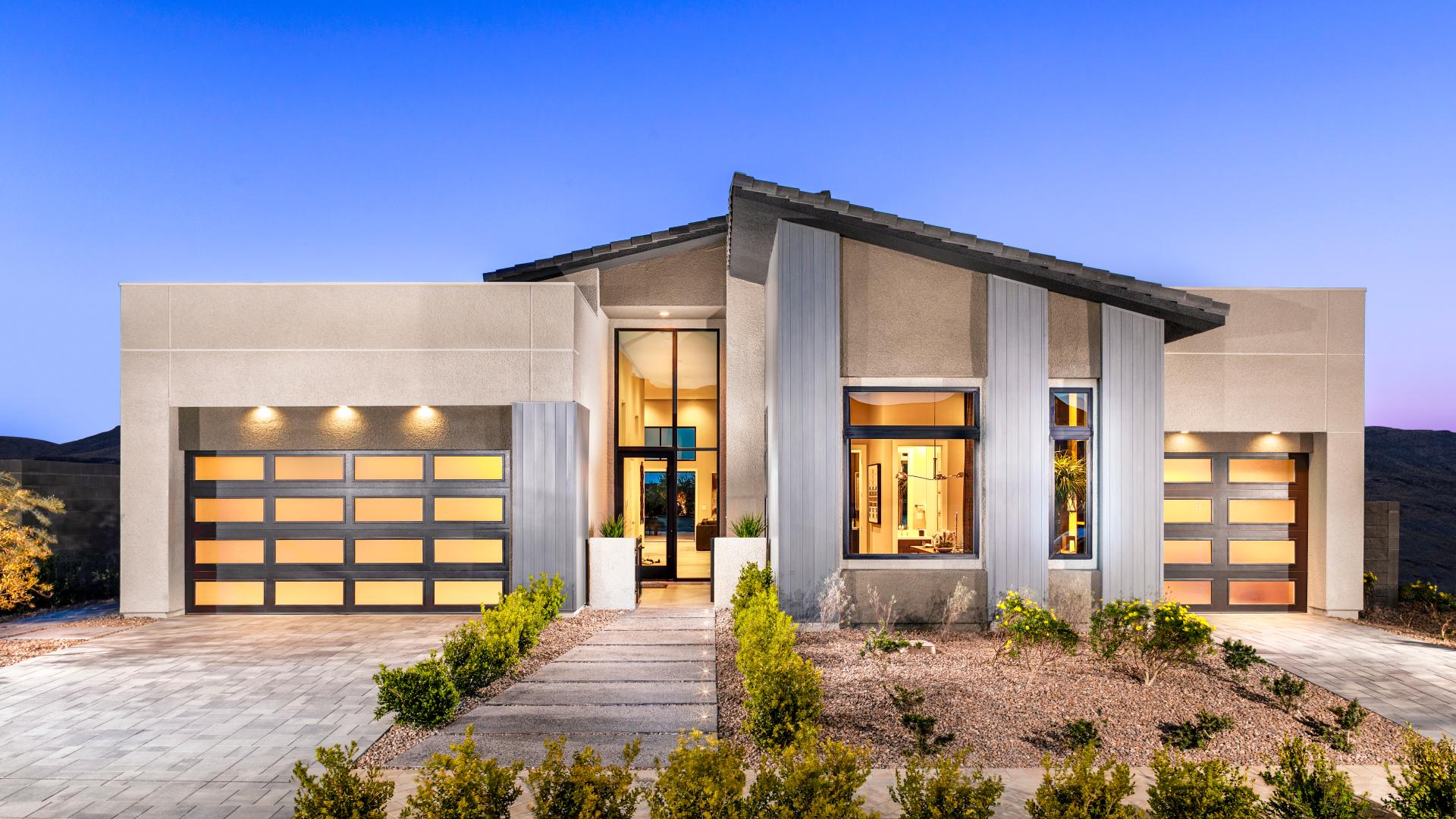 Contemporary home exterior with three-car garage at Ascension Ridgeline Collection by Toll Brothers