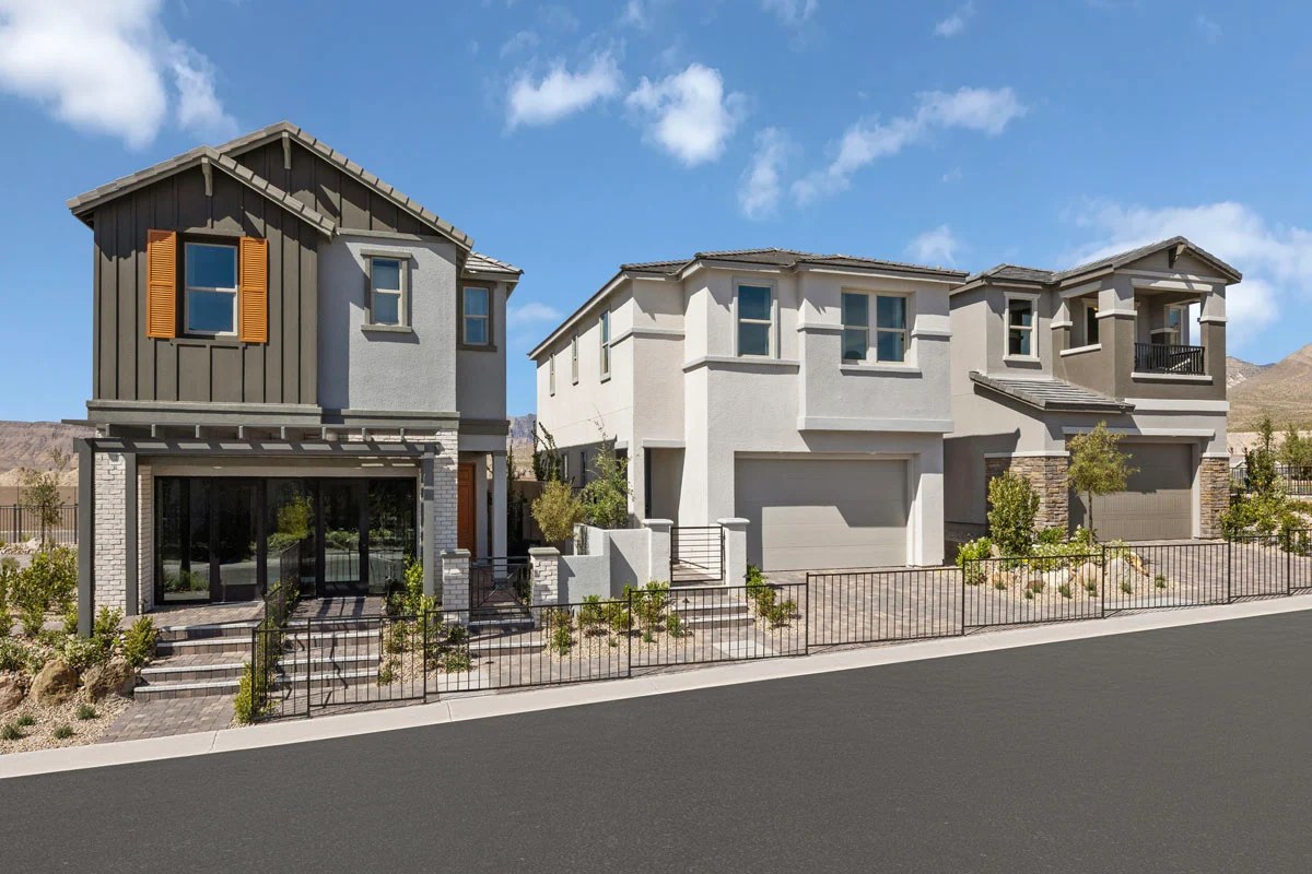 Row of two-story homes with front gardens and iron fencing at Caldwell Park by KB Home