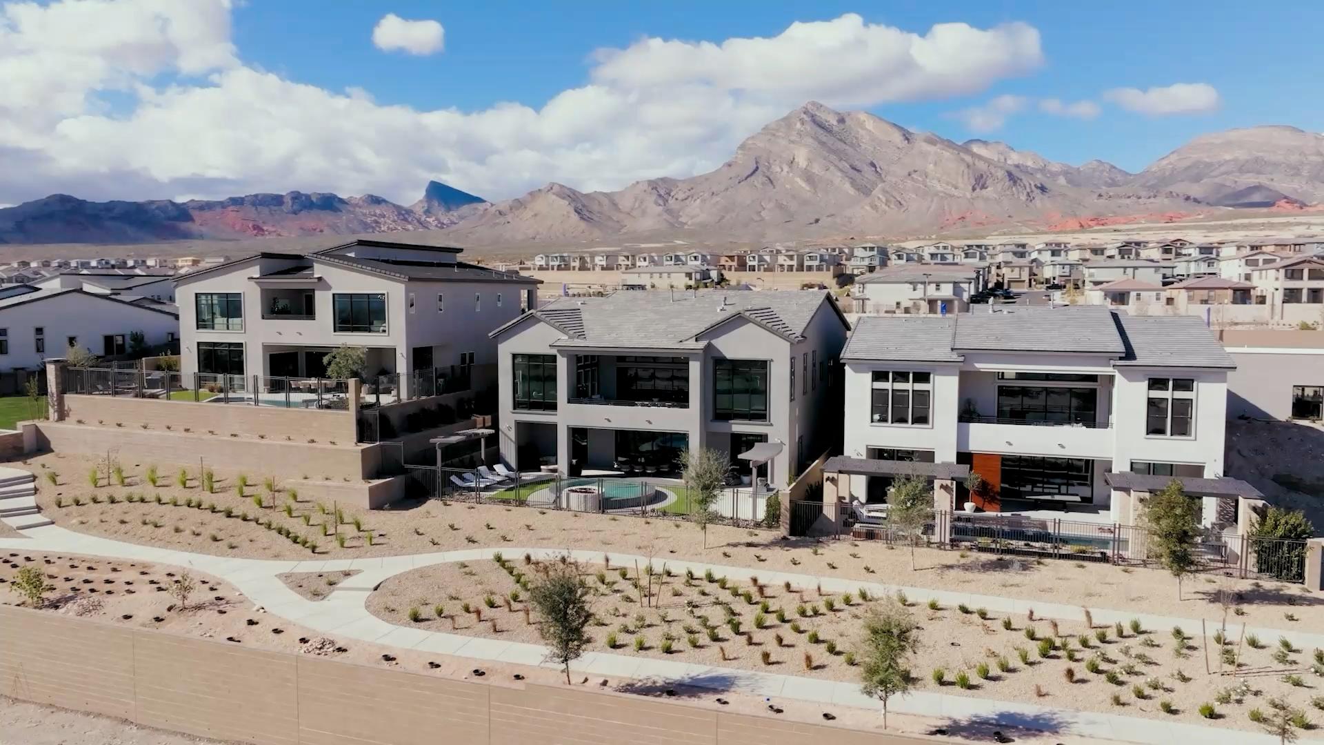 Aerial view of modern homes at Glenrock by Toll Brothers with mountains behind