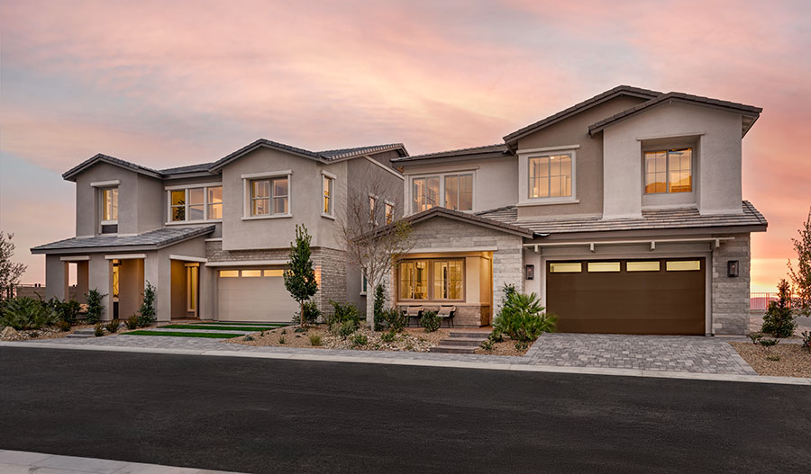 Two-story homes along a street at Primrose Park by Richmond American Homes at sunset