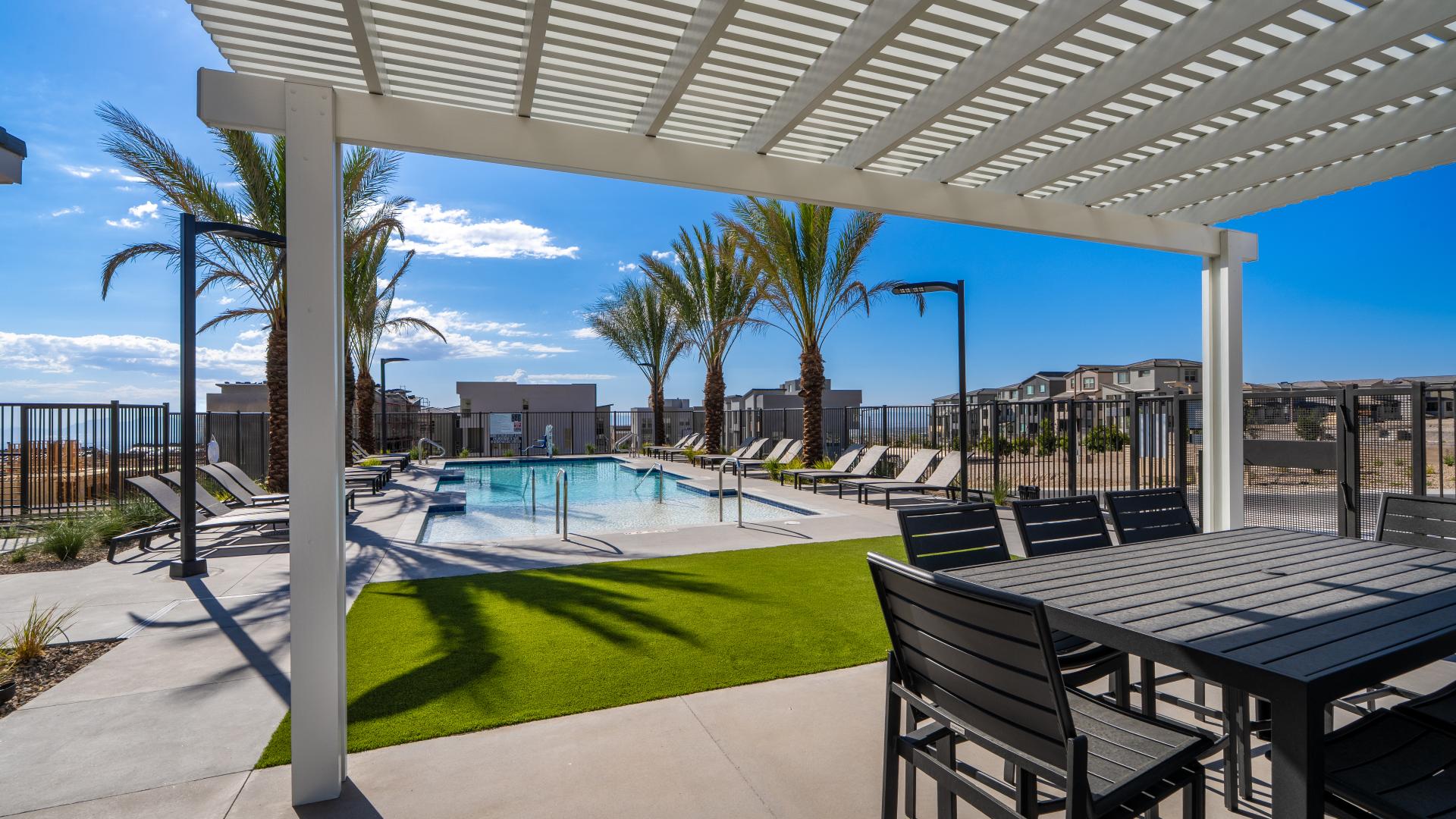 Community pool and shaded pergola at Raven Crest by Toll Brothers