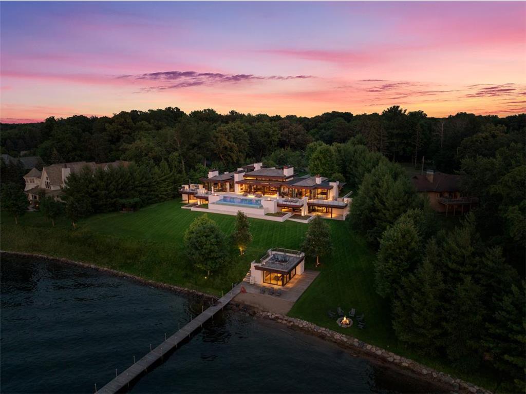 Aerial view of 20670 Linwood Road in Deephaven at sunset, with its lakeshore and boathouse