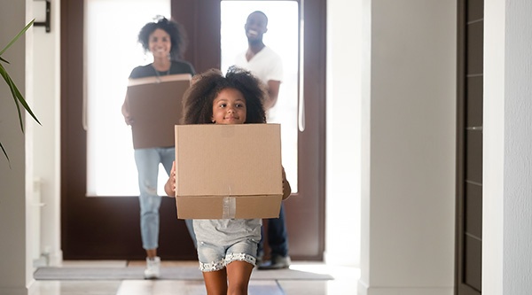Girl carrying a box during a move.