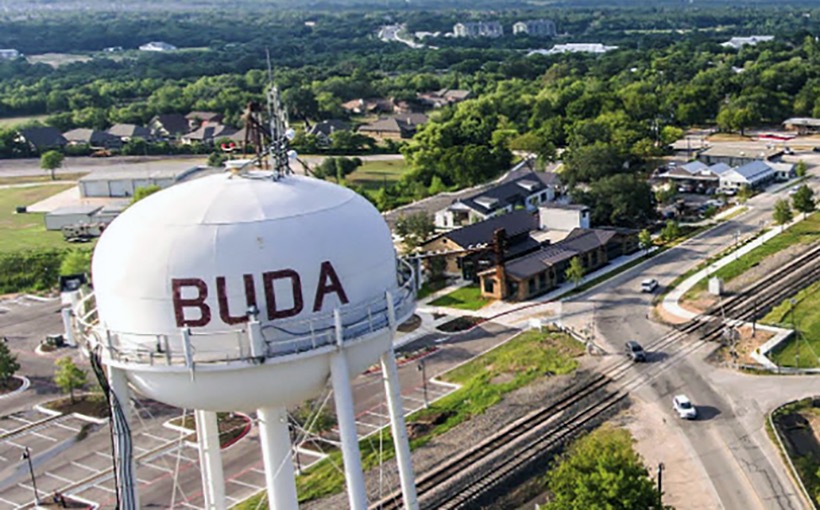Buda TX real estate and homes for sale near downtown Buda featuring the Buda water tower in Central Texas
