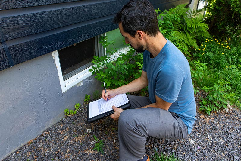 home inspector writing on clipboard