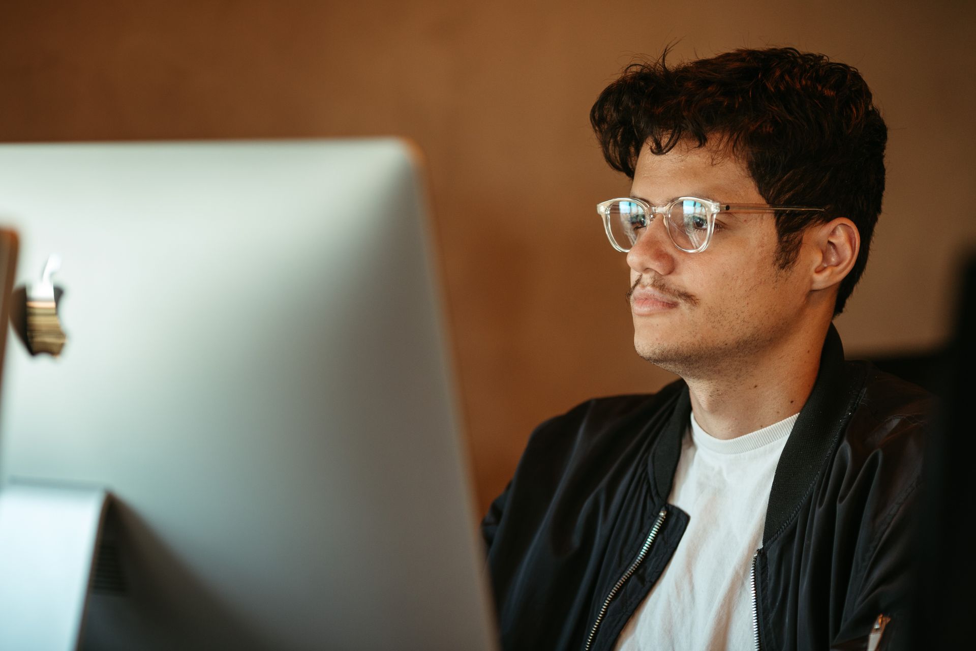 person thinking while at a computer