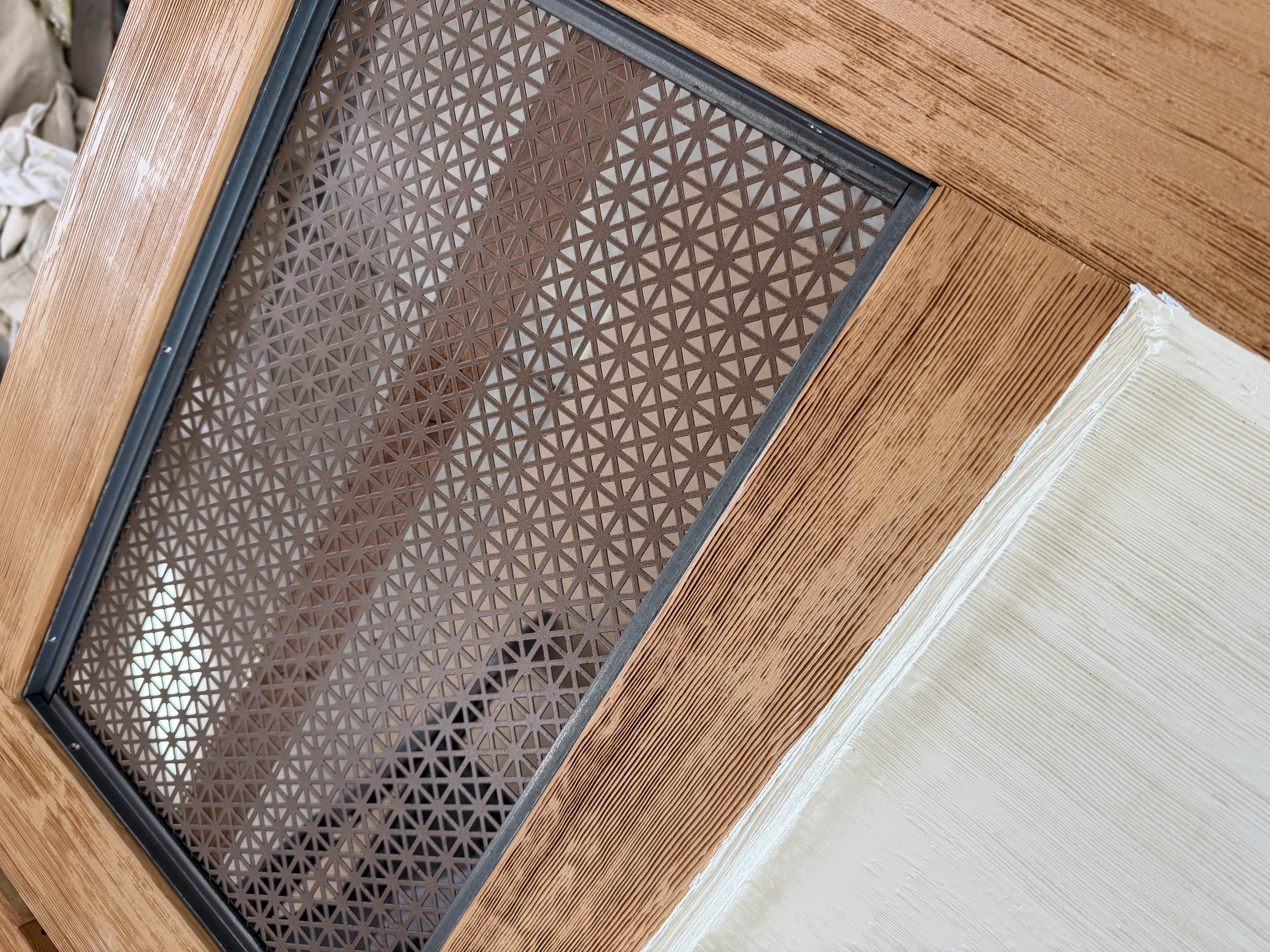 Bronze painted perforated metal door panels installed