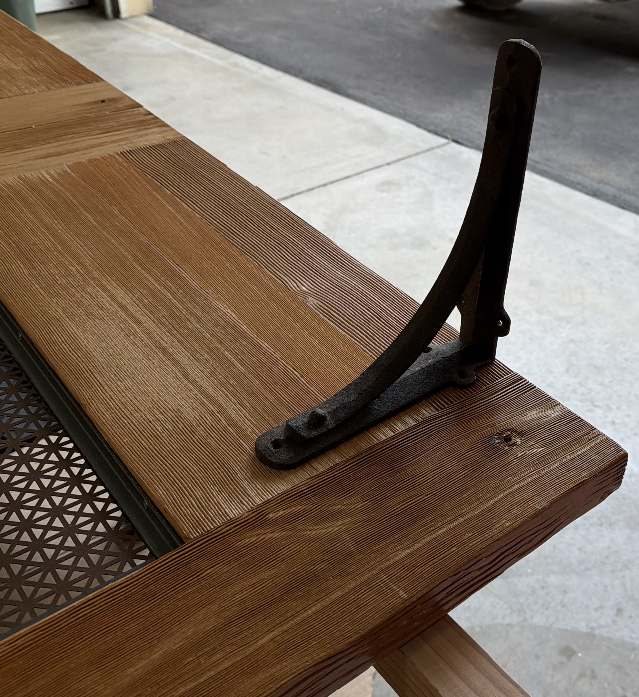 Cast iron shelf brackets used as feet to support the vintage door room divider