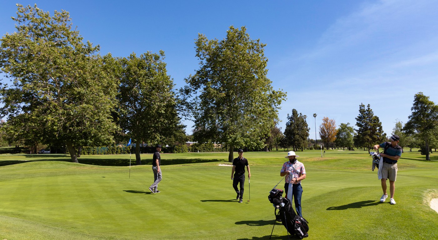 Golfers on the course at Mesa Verde Country Club in Costa Mesa