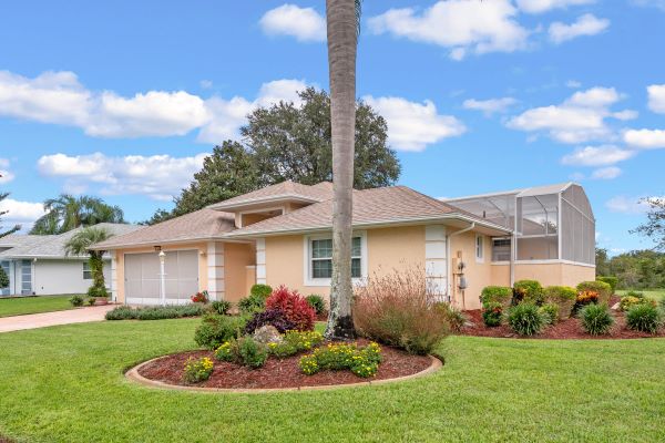Front image of Florida home with palm trees