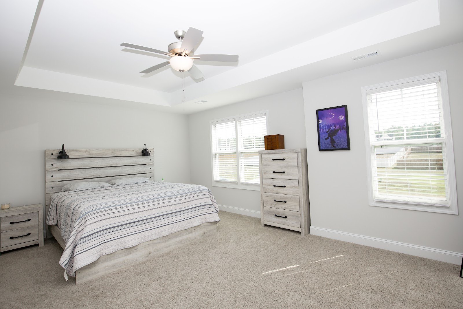 Primary bedroom with a tray ceiling and ceiling fan at 221 Vega Lane