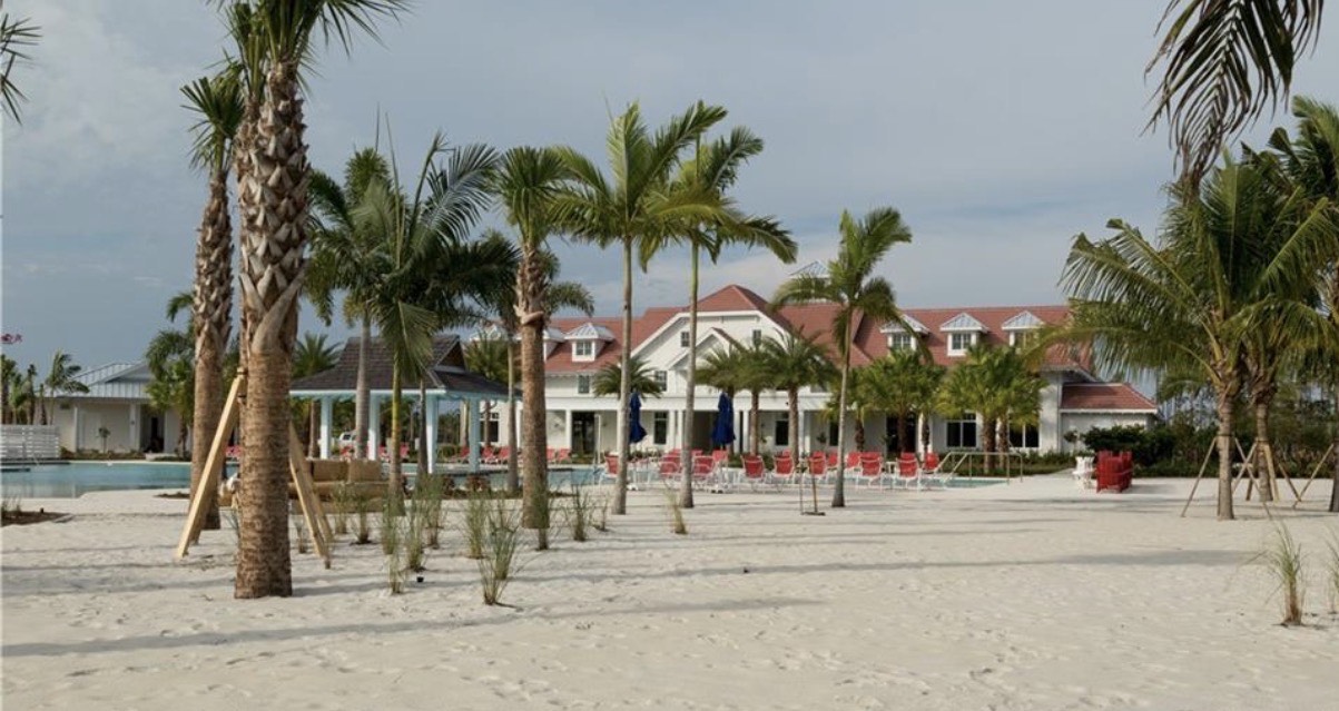 The image showcases luxury waterfront homes in the Isles of Collier Preserve, featuring magnificent furnished saltwater pools that overlook scenic lakes and lush preserve areas. These residences embody modern coastal luxury with spacious outdoor private oases, perfect for enjoying the ultimate Florida lifestyle.