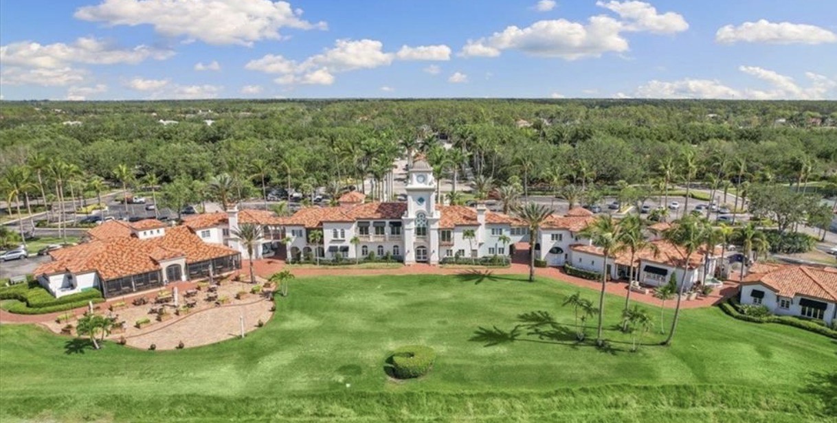 An aerial view of Village Walk Naples showcases the beautifully maintained gated community, featuring multiple serene lakes and lush, mature landscaping, highlighting the tranquil atmosphere and resort-style amenities available to residents. This sought-after community is conveniently located near all the amenities, making it an appealing option for prospective property consumers.