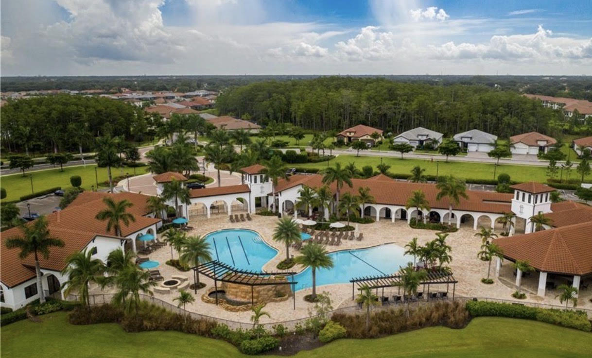 An aerial view of Arborwood Preserve in Fort Myers, showcasing the expansive 332-acre master-planned community, which features serene lakes and preserved natural areas, along with amenities like a resort-style pool and tennis courts. The image highlights the beautiful homes and neighborhoods that make Arborwood Preserve a perfect place for families and residents.