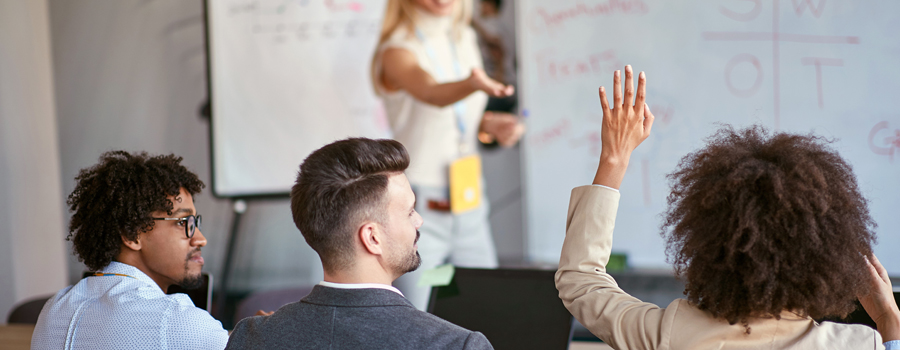 Ask The Most Relevant Questions - Person With Their Hand Up
