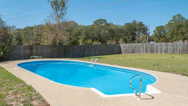 Pool, deck and backyard.
