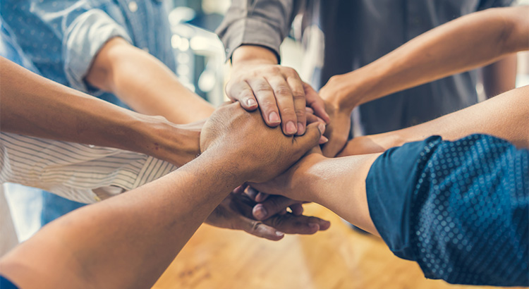 hands coming together to work together