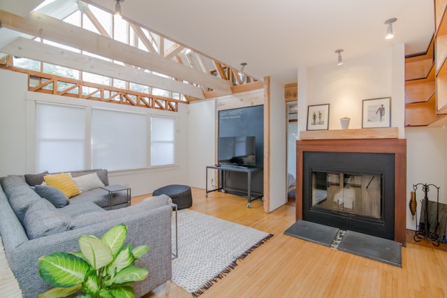 A clean modern living room with a fireplace and natural light