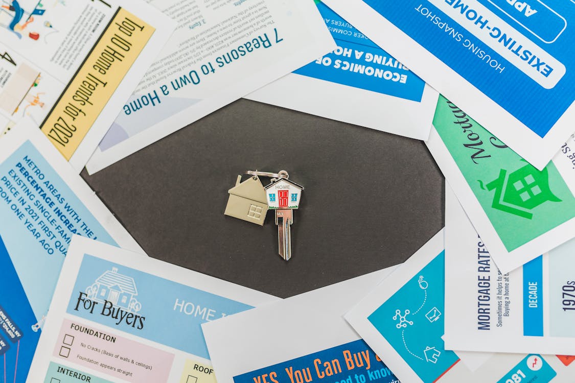 house keys surrounded by home-buying-related papers