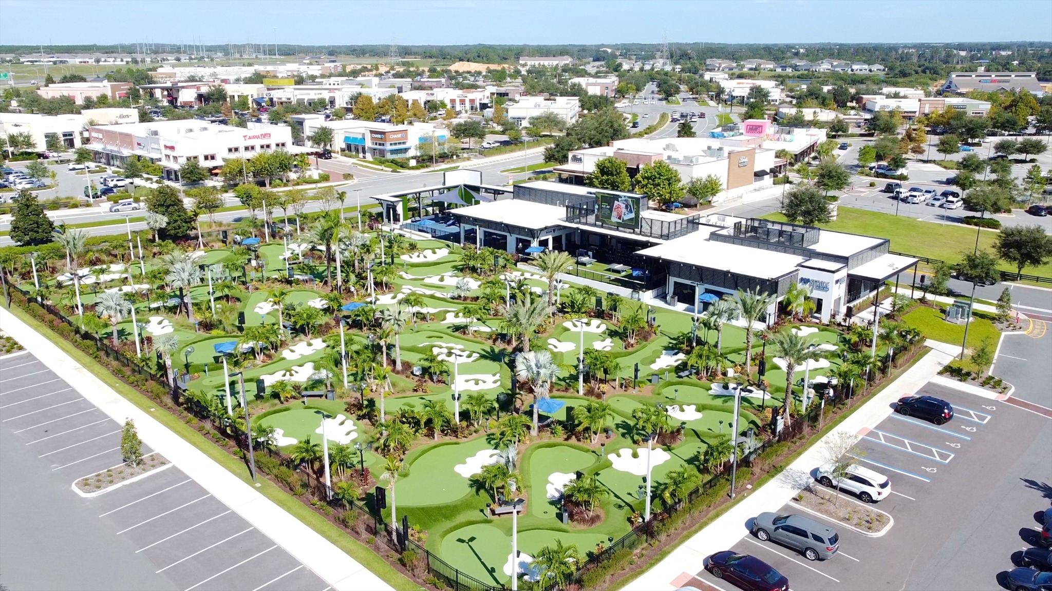 Aerial view of PopStroke's putting courses and nearby Hamlin businesses