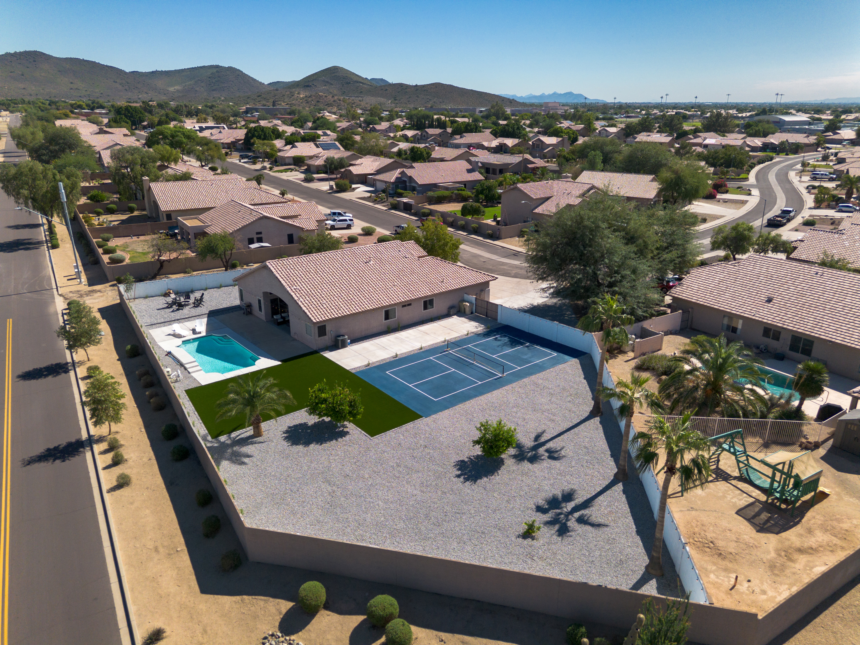 Aerial of Glendale AZ home with pool, pickleball court, turf and fire pit on a 0.44-acre lot
