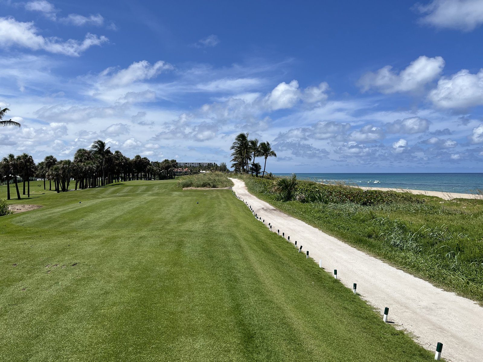A golf fairway with the ocean beyond